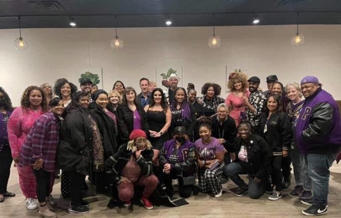 Prince 365 Clubhouse community group photo in a restaurant banquet room on a Minneapolis trip
