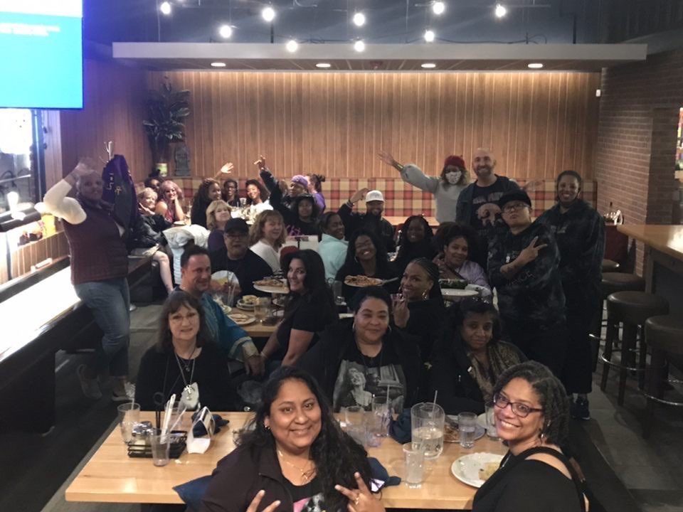 The family gathered around long tables at a restaurant