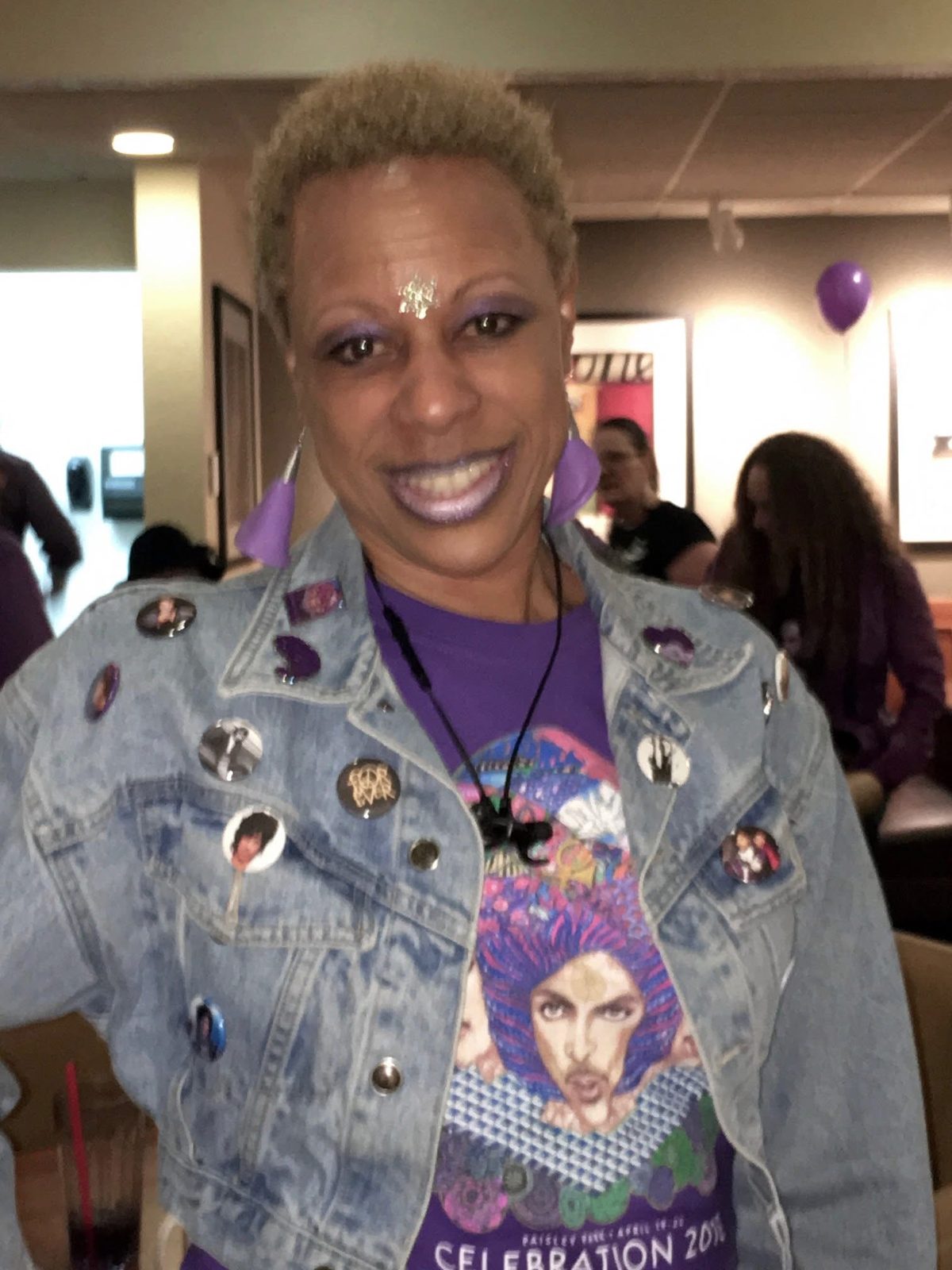 Denim jacket with pins and a Celebration 2018 shirt